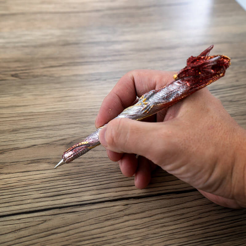 Writing pen shaped like a sparkly red and gold dragon