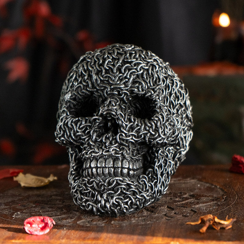 Skull figurine appearing to be made of chains in faux-silver