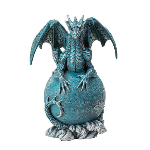 Figurine of a blue dragon on the planet Uranus with tail coiled around and water waves below