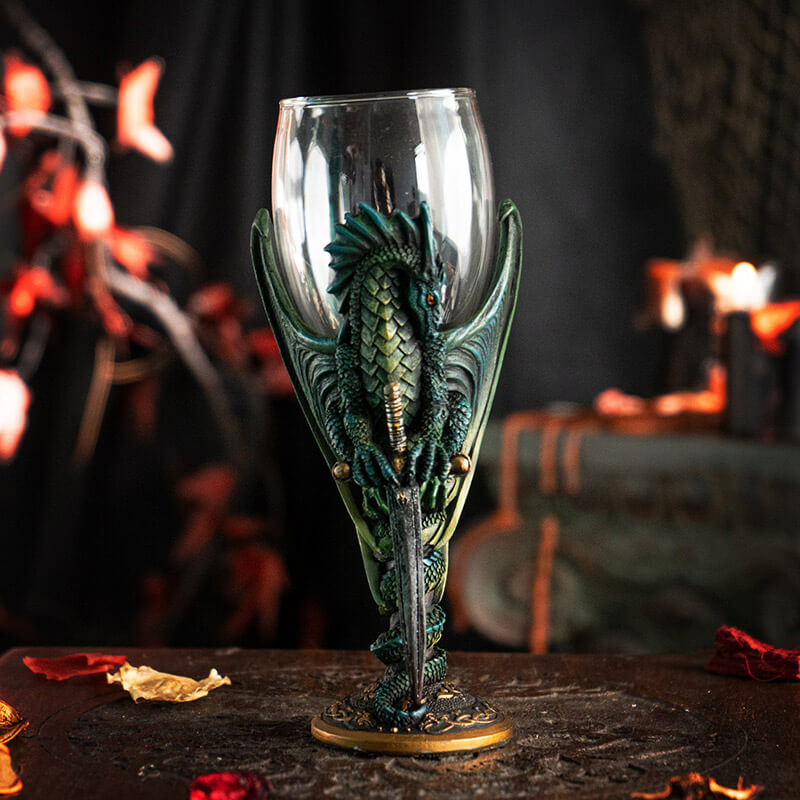 Glass topped goblet with green dragon and sword making up the stem