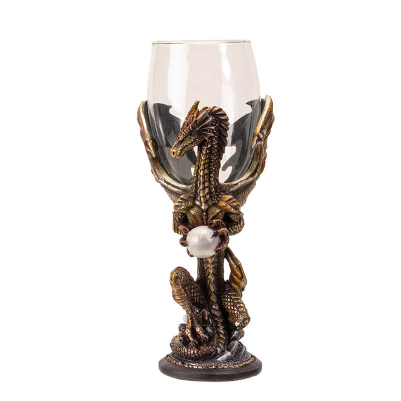 Goblet with glass at the top, dragon in shades of orange/brown holding a pearl makes up the stem