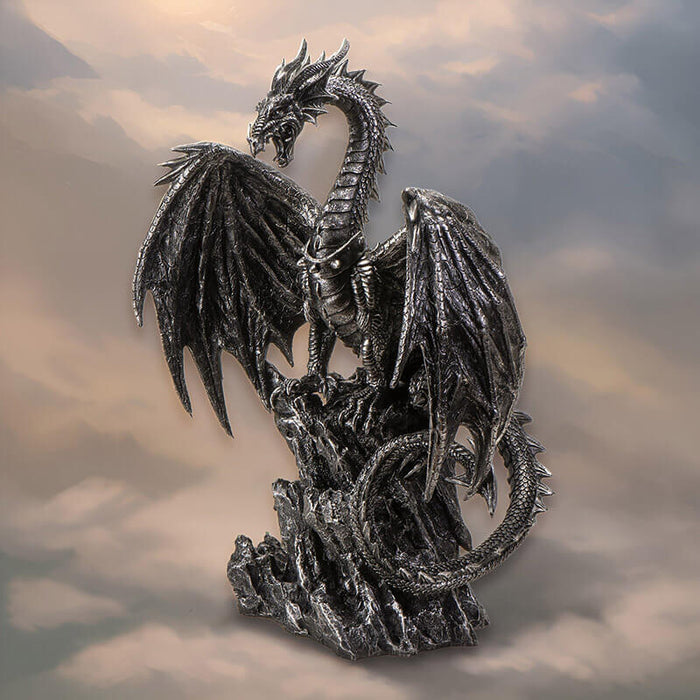 Figurine of black dragon with spiked collar sitting on rock