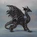 Large black dragon figurine with detailed scales, standing with mouth shut, tail curled.
