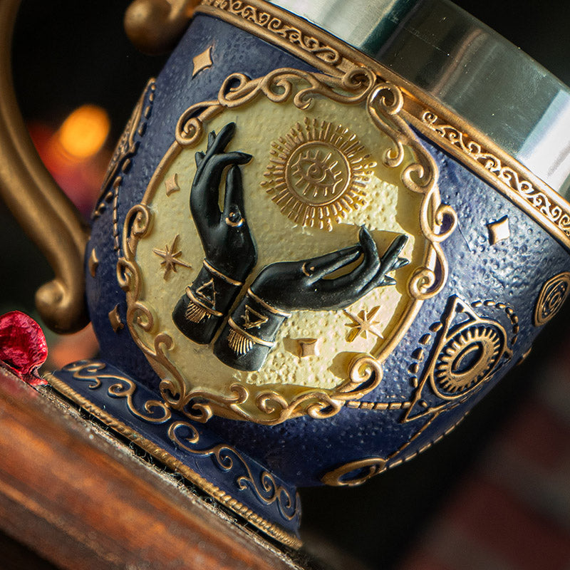 Teacup with stainless steel insert, tarot hands, eye motif, fortune telling themed with gold on blue.