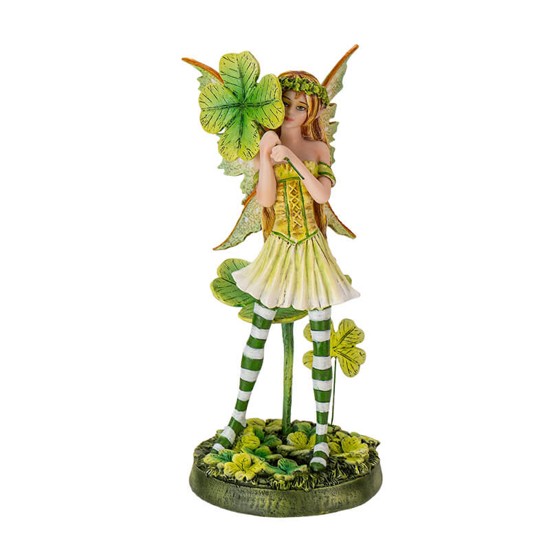 Figurine of a fairy wearing a green dress with four leaf clovers and striped stockings