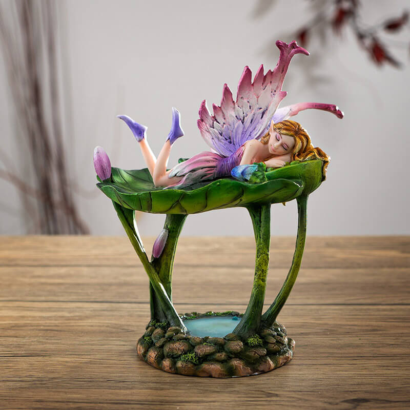 Figurine jewelry dish tray with raised lotus leaf above a pond. Fairy in pink and purple with winged frog on the leaf-dish