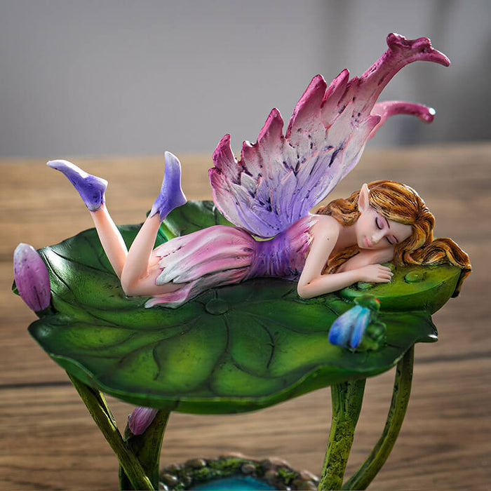 Figurine jewelry dish tray with raised lotus leaf above a pond. Fairy in pink and purple with winged frog on the leaf-dish