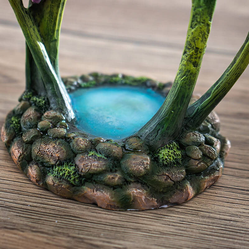 Figurine jewelry dish tray with raised lotus leaf above a pond. Fairy in pink and purple with winged frog on the leaf-dish