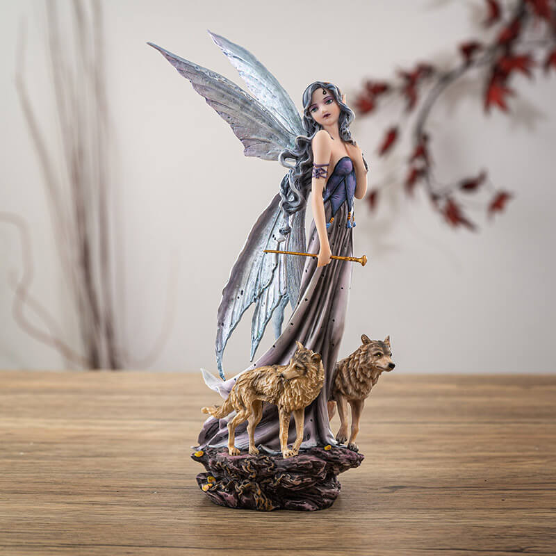Figurine of fairy with gray wings and hair and purple dress walking with two tan wolves. Fae carries a gold wand.
