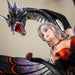Figurine of fairy in black and red holding a rose, with a black snake dragon wrapped around her protectively. Closeup of faces