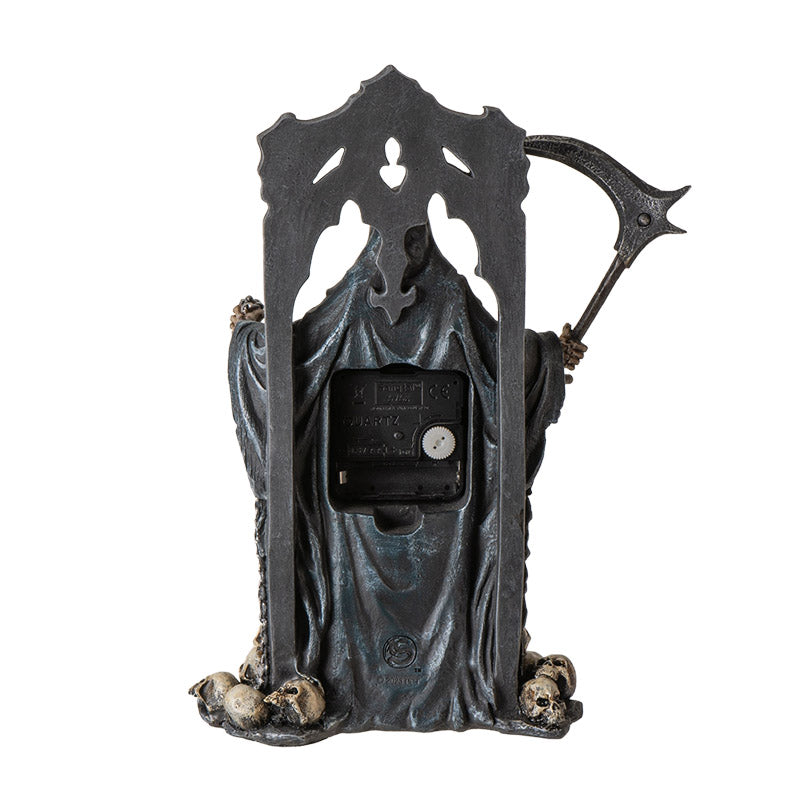 Clock figurine of Grim Reaper holding scythe, with skulls. Shown from the back iwth battery compartment