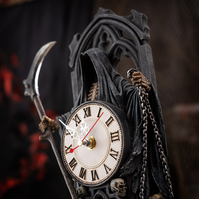 Clock figurine of Grim Reaper holding scythe, with skulls.