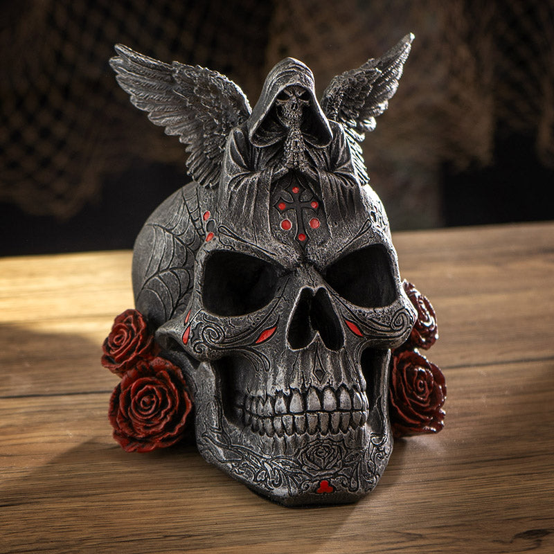 Skull figurine with Grim Reaper on top, red accents, roses
