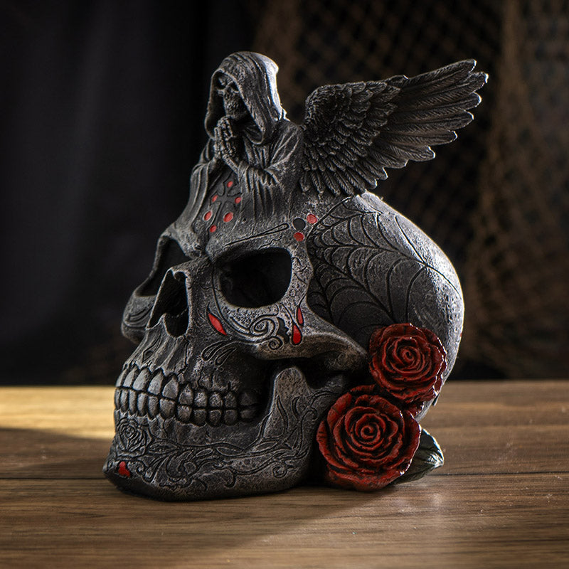 Skull figurine with Grim Reaper on top, red accents, roses