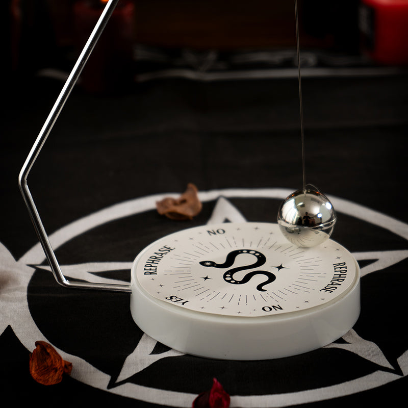 Pendulum decision maker with swinging metal ball and snake motif