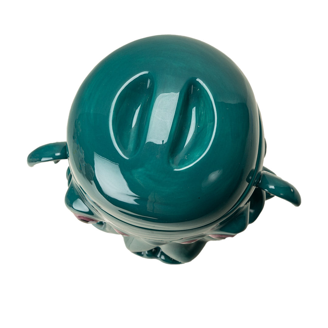 Ceramic cookie jar in teal, pink eyed, tentacled Cthulhu monster shaped, shown from the top, indented lid