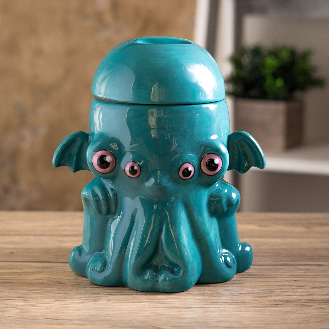 Ceramic cookie jar in teal, pink eyed, tentacled Cthulhu monster shaped