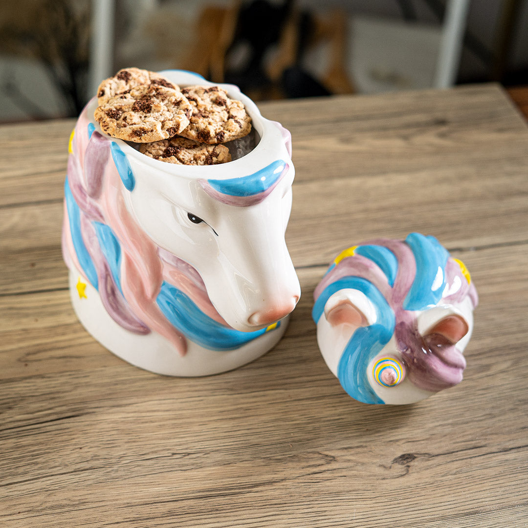 Ceramic unicorn head cookie jar, mane with pink and blue, horn with pink, blue yellow, and yellow stars, shown open with cookies