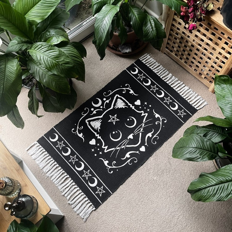 Cotton rug, white on black with fringe. Cat face with pentacle, moon and heart designs