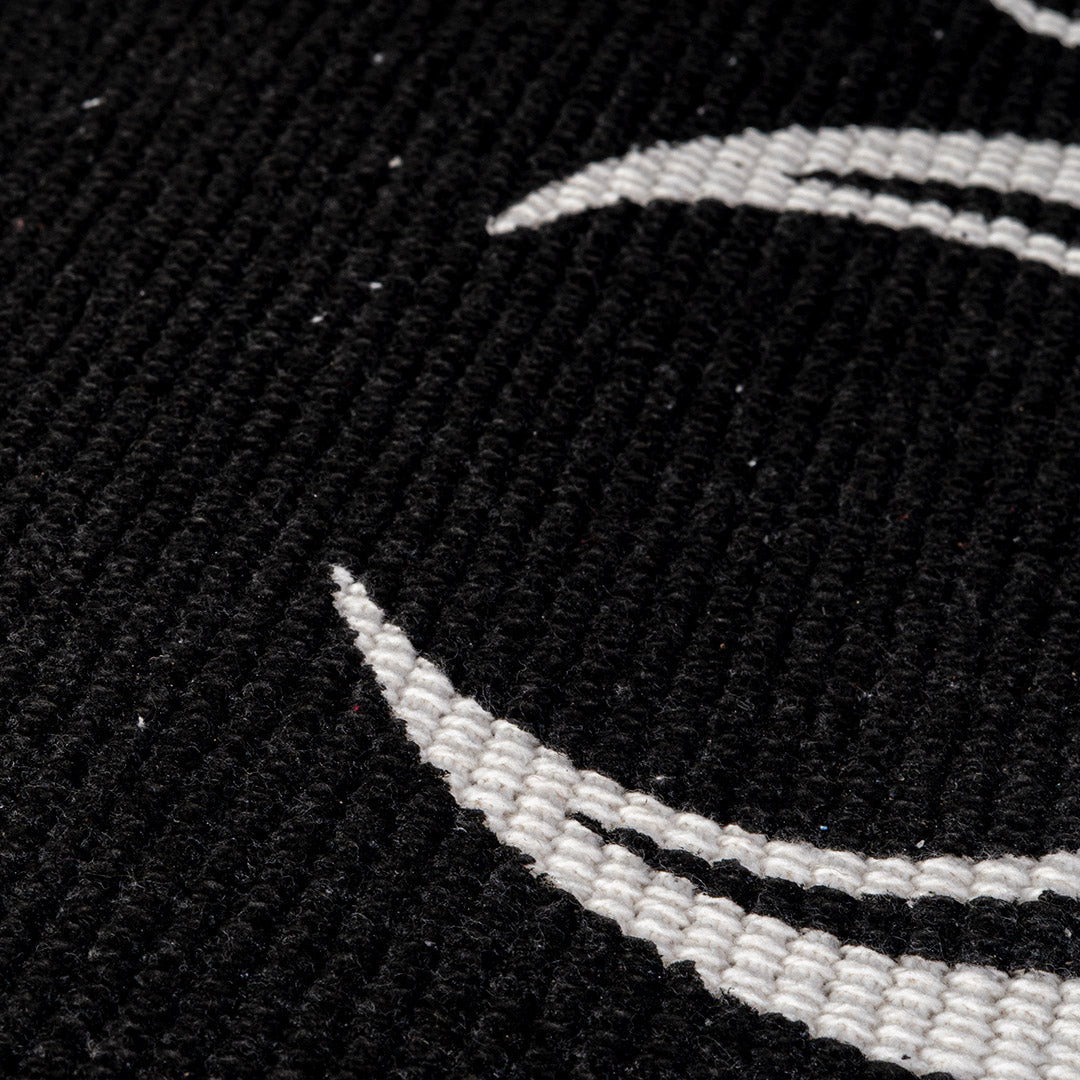 Closeup of rug fibers, cotton, white moon on black