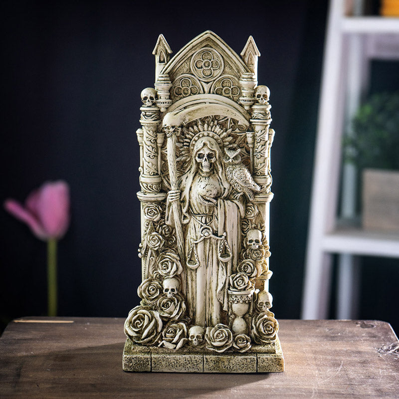Faux-ivory figurine of Santa Muertes skeleton woman with scythe and owl, surrounded by skulls and roses, hourglass, ornate Gothic architecture