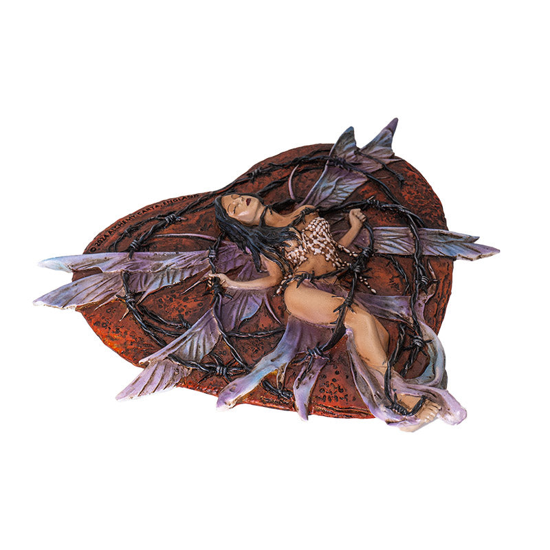 Wall plaque of dark haired fairy with light purple wings trapped in barbed wire against a red heart