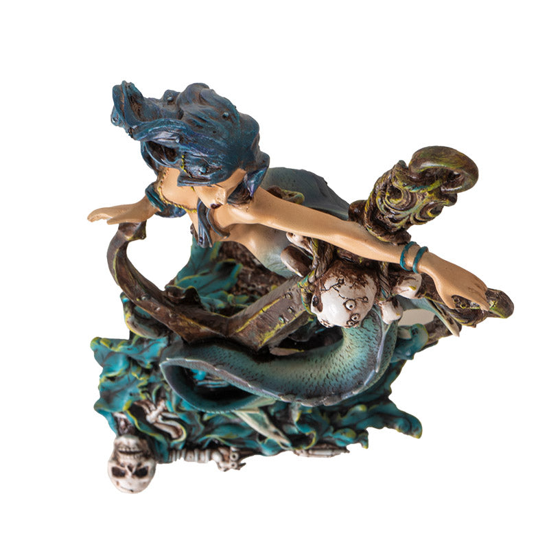 Figurine of a mermaid wrapped around an anchor with a skeleton and seaweed, shown top down
