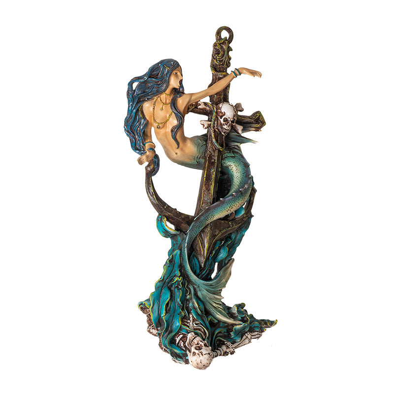 Figurine of a mermaid wrapped around an anchor with a skeleton and seaweed