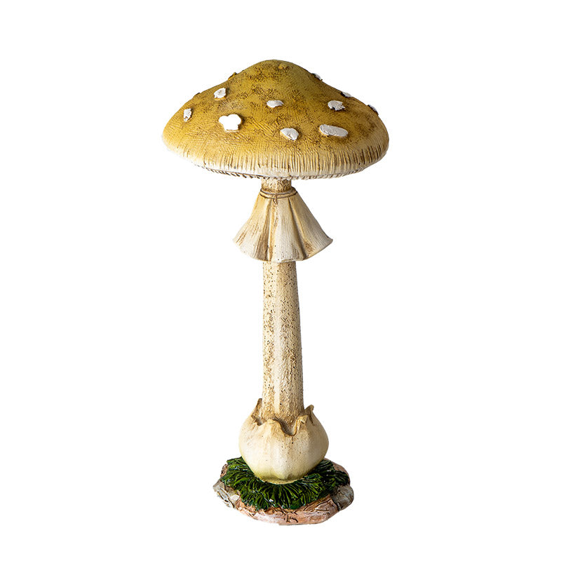 Figurine of tall yellow toadstool with white spots