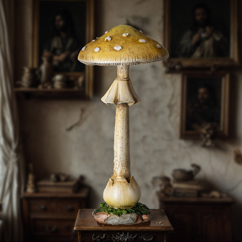 Figurine of tall yellow toadstool with white spots