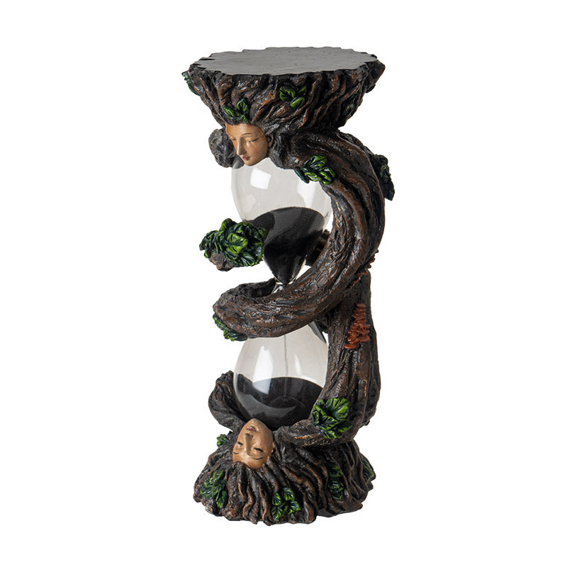 Sandtimer with glass hourglass, black sand, and ent faces on either end with spiraling roots