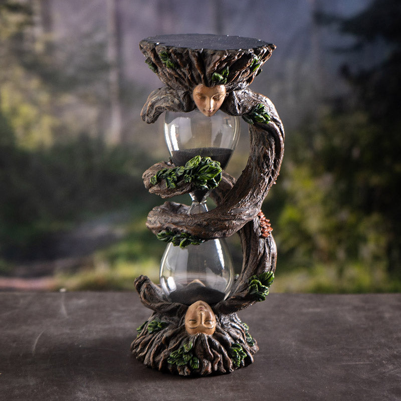 Sandtimer with glass hourglass, black sand, and ent faces on either end with spiraling roots