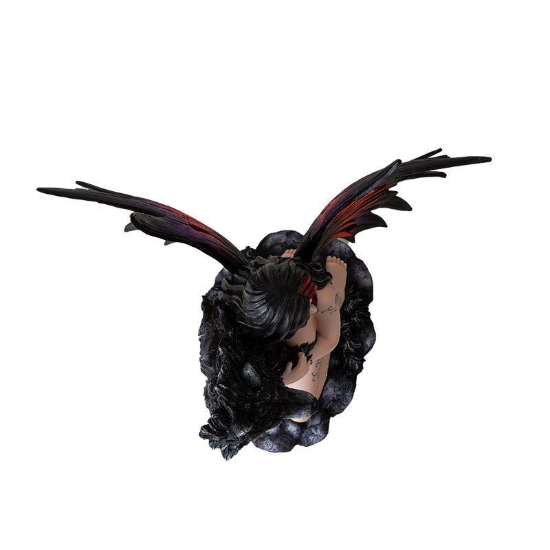 Figurine of fairy with red and purple wings kneeling on stone, black wolf face with fur wrapping around the tattooed pixie, shown top down