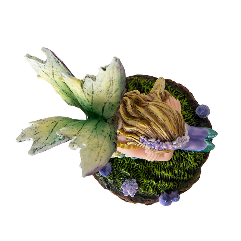 Fairy Figurine with blond pixie sleeping on moss, green wings & dress with purple stockings, accents, mushrooms. Shown top down