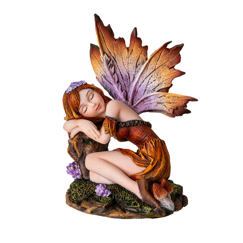Fairy figurine, brown-orange dress, hair, wings, sleeping on a stump