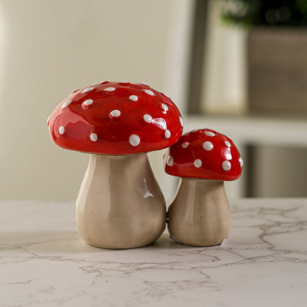 Pair of salt and pepper shakers shaped like red and white fly agaric (amanita) mushrooms