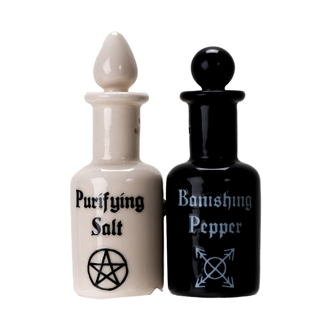 Salt and pepper shakers shaped like potion bottles. White one reads "Purifying Salt" and black one has "Banishing Pepper" with arcane symbols, attached via magnets to one another