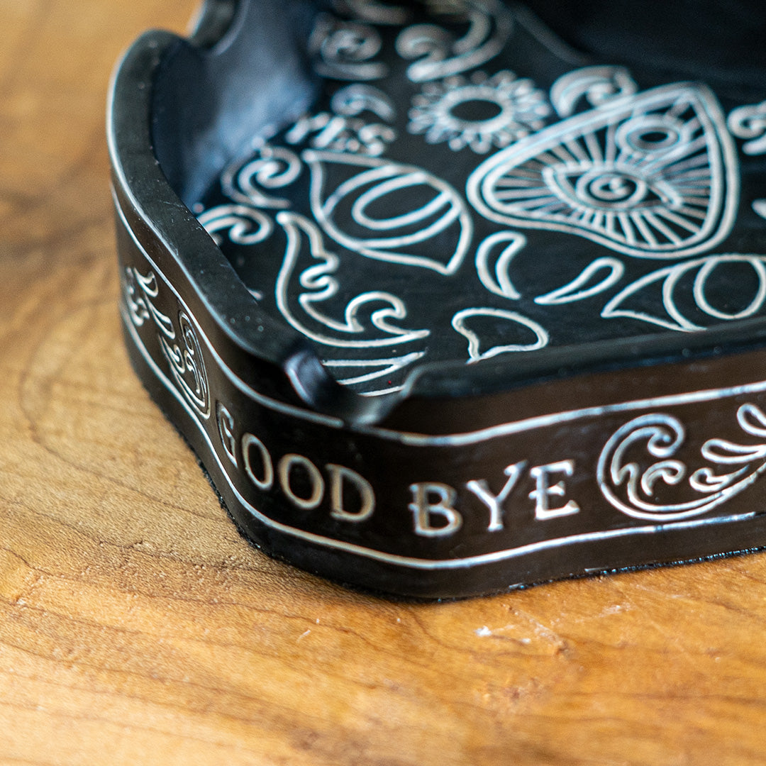 Black cat shaped ashtray with spiritual ouija board inspired designs, closeup