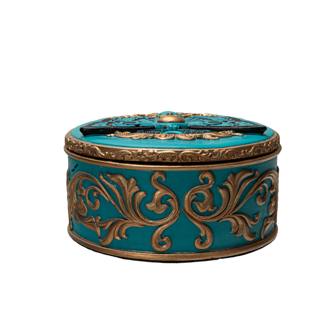 Round trinket box with blue base and moth design, gold accents, skull and swirls