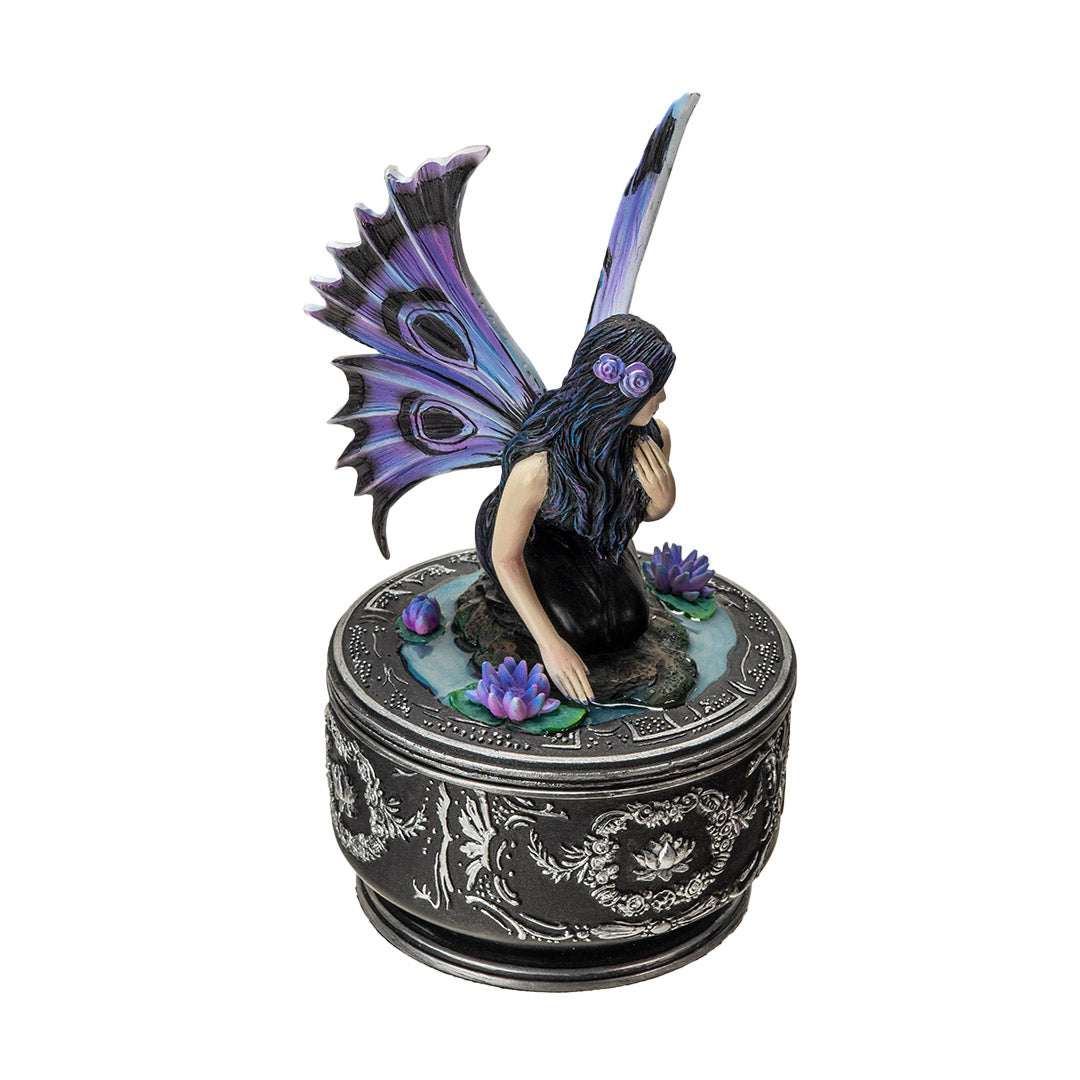 Trinket box with black base and silver designs. On the lid is a fairy in black dress with purple and blue wings accented in black, sitting amidst water lilies