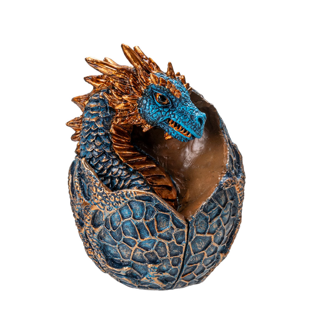 Figurine of a dragon hatching from an egg. Blue textured egg, dragon is indigo with golden accents on horns and spines