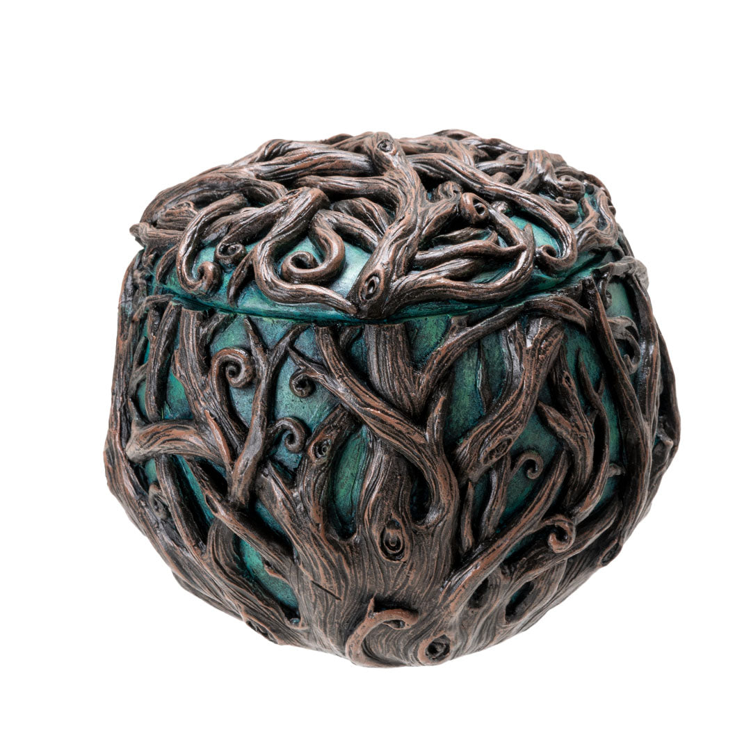 Round trinket box with the teal face of Gaia (Mother Earth), covered in branches, shown from the back