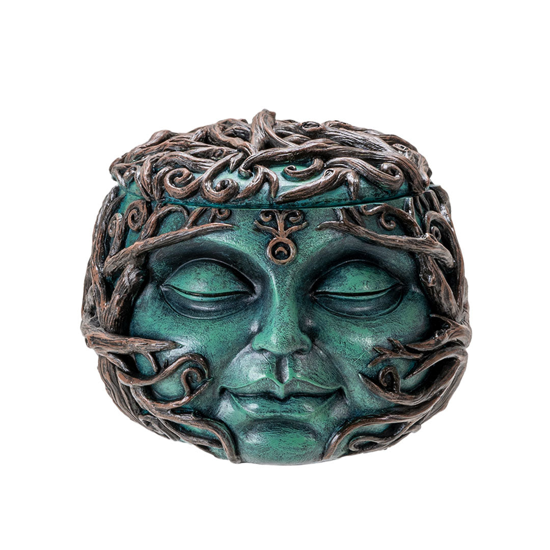 Round trinket box with the teal face of Gaia (Mother Earth), covered in branches