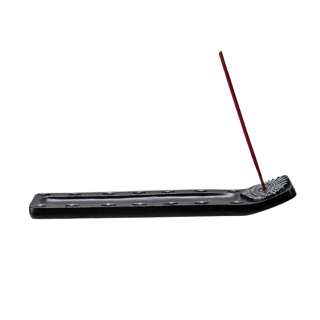 Black incense burner with silver eye design and silver stars, shown with incense stick