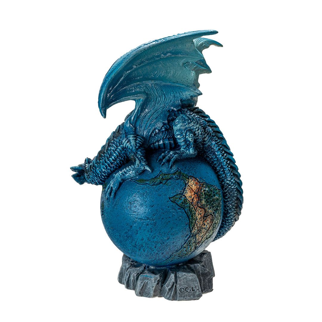 Dragon figurine, perched on planet earth. Blue dragon with tail curled around the globe