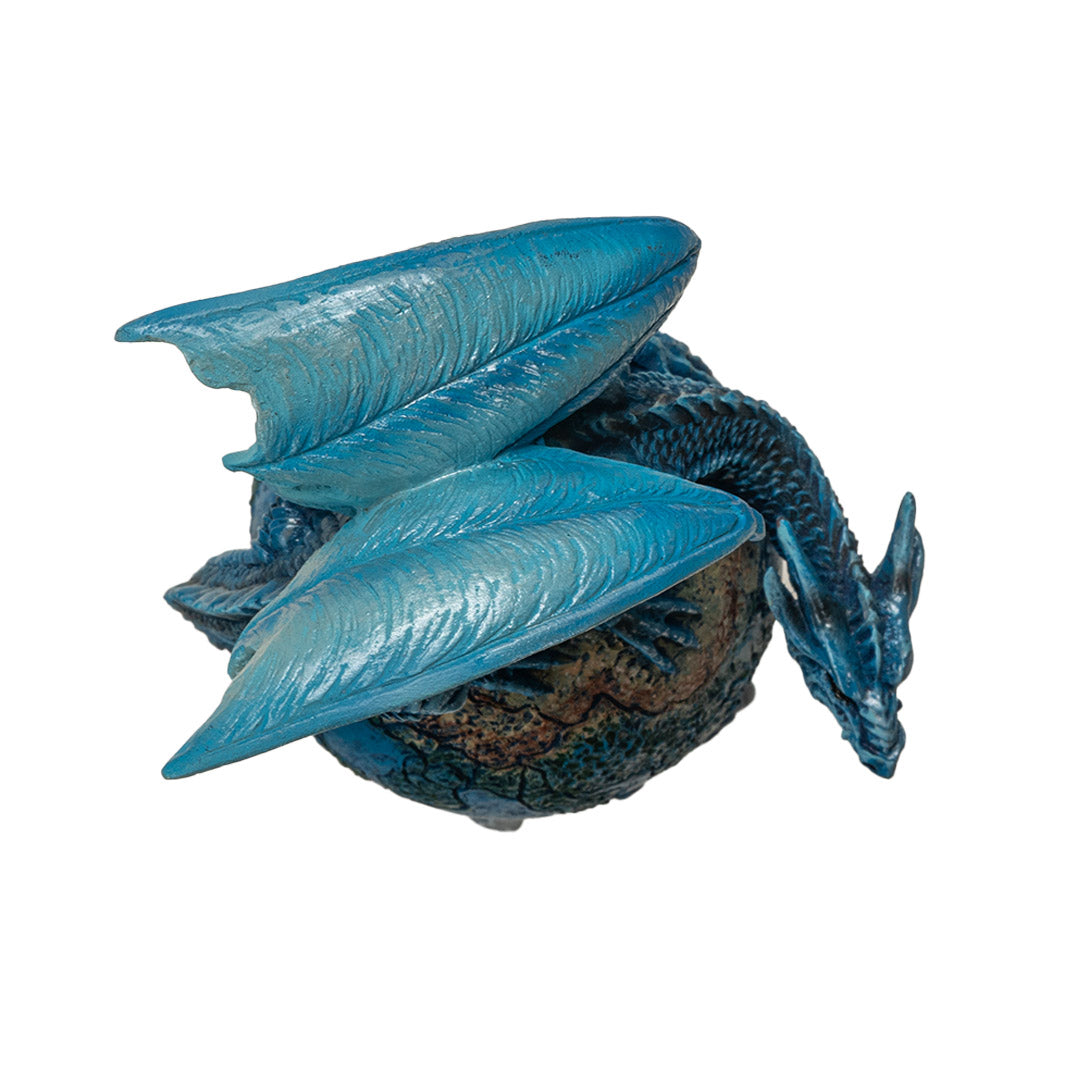 Dragon figurine, perched on planet earth. Blue dragon with tail curled around the globe, shown top down