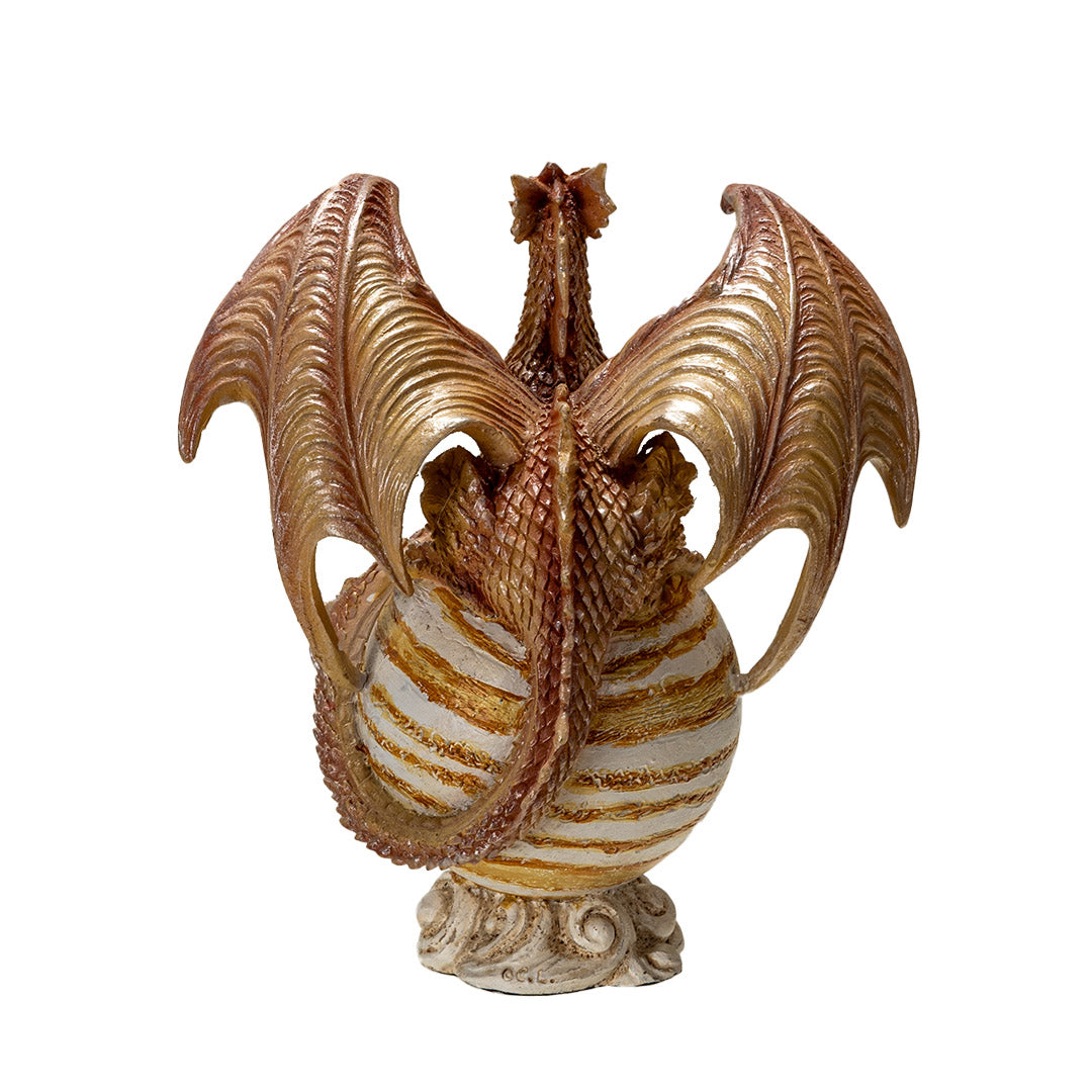 Tan dragon with golden orange eyes perched with crossed talons on the planet Jupiter, striped tan and white on a cloud base, shown from the back
