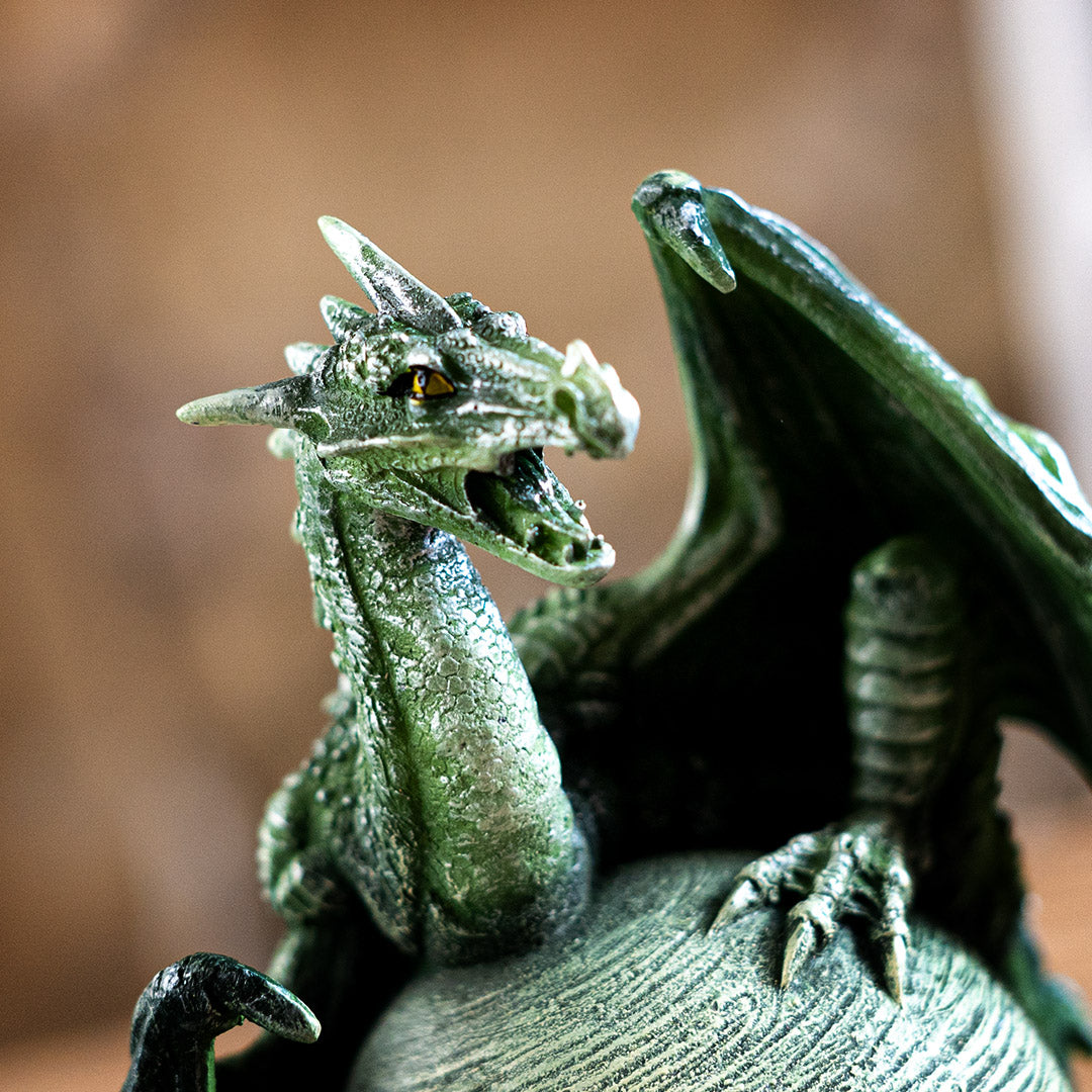 Closeup of green dragon, open mouth, yellow eyes, spines