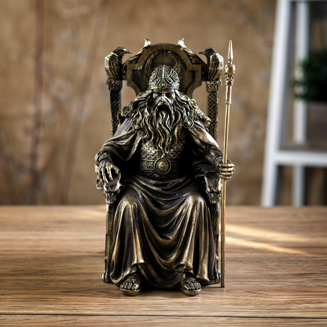 Figurine in faux bronze of Norse god Odin on throne with ravens and staff