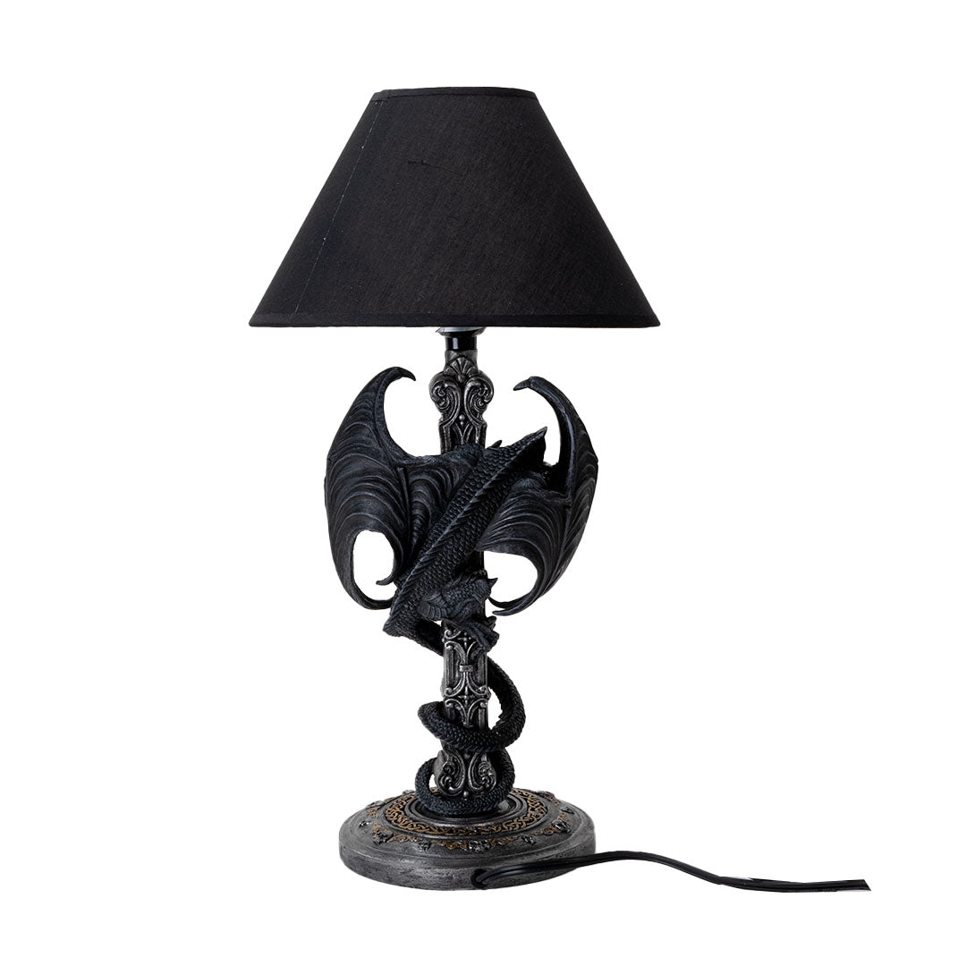 Lamp with black shade, black dragon twining around the base in faux-silver shaped like a Gothic Celtic cross. Shown from the back
